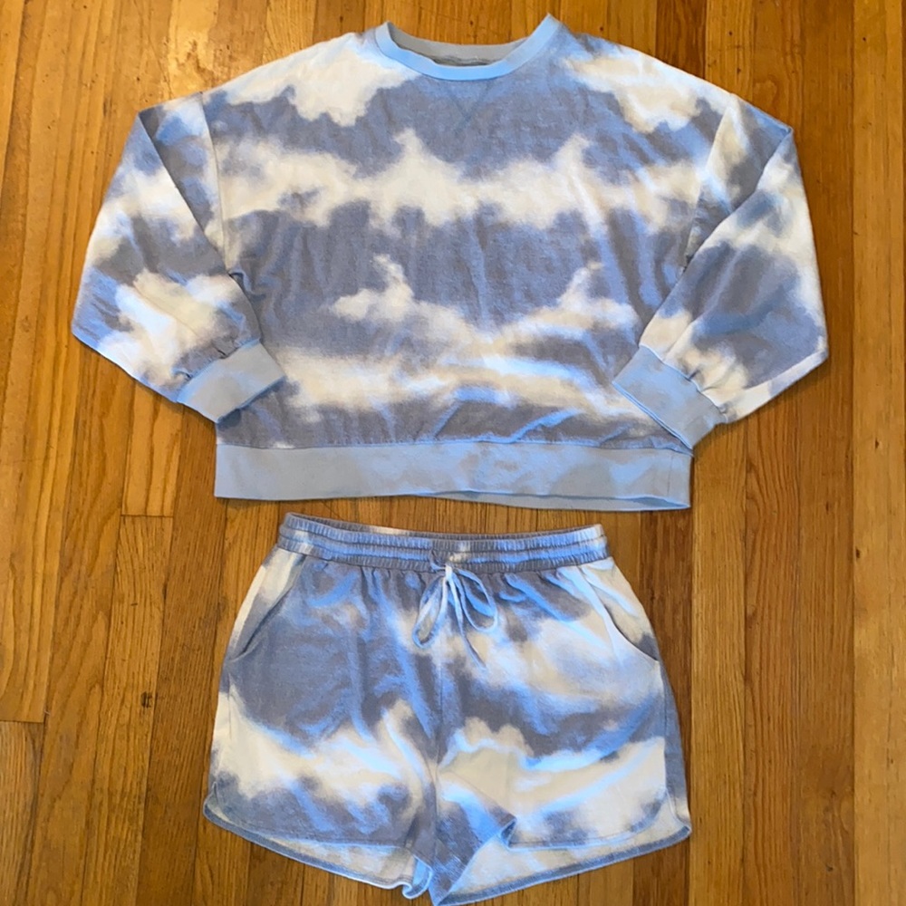 Two piece blue and white tie-dyed sweatshirt and shorts set.